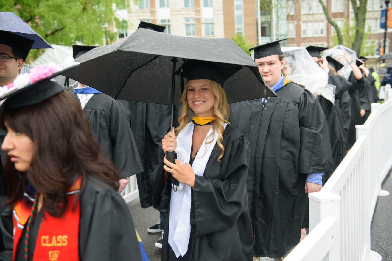 students process into commencement tent
