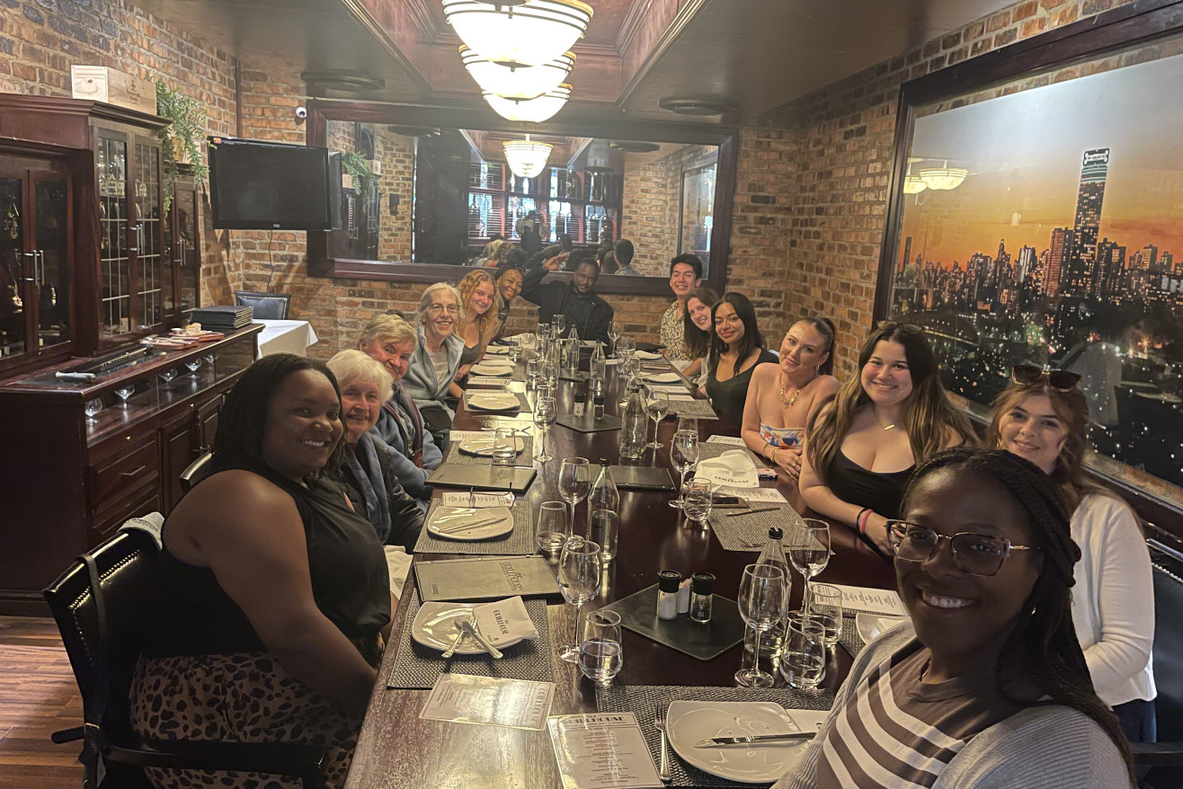 Students and faculty pose at a restaurant in South Africa