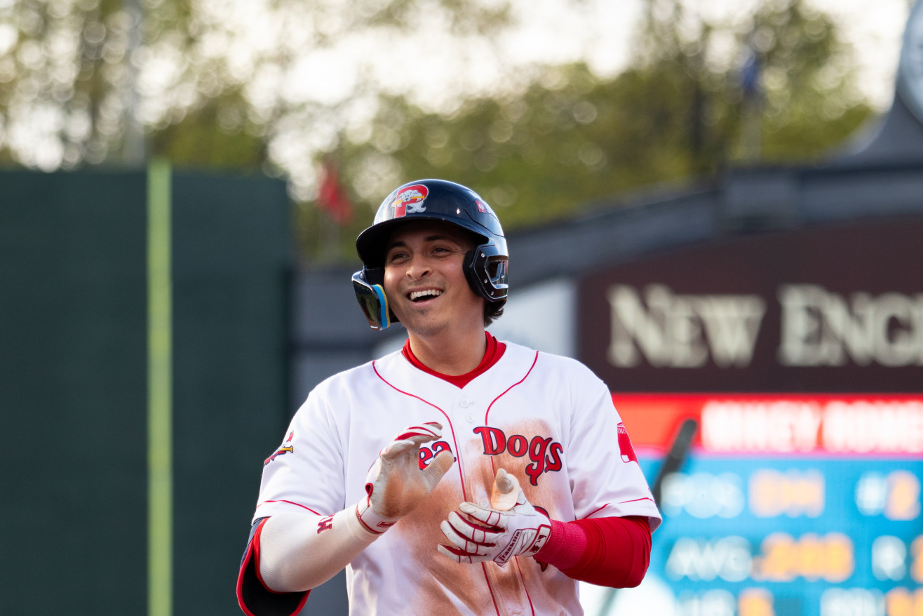 a man wearing a baseball uniform stands on base 