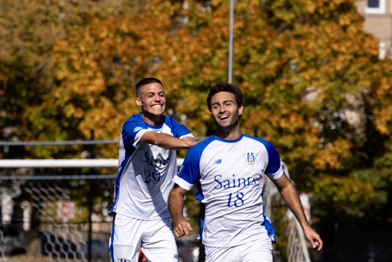 two men wearing soccer jerseys 