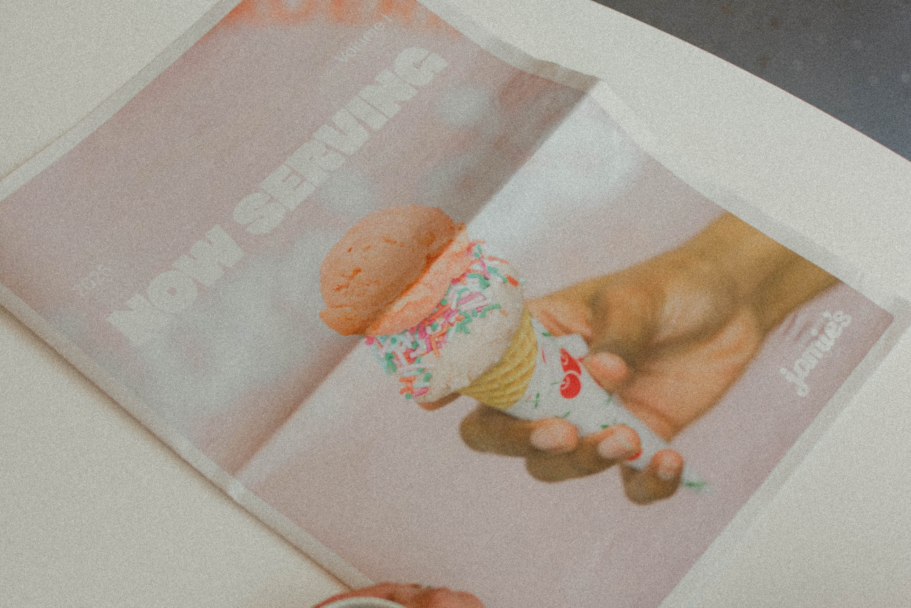 A cup of coffee next to the Jamie's Ice Cream newspaper print