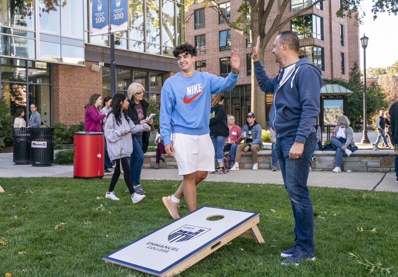 Students playing bean bag toss outside